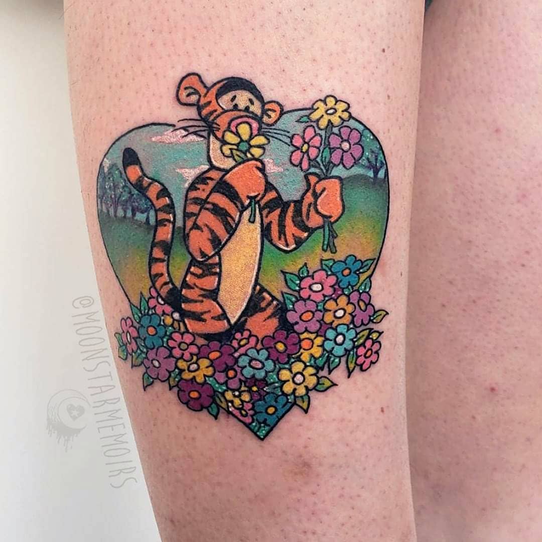 Tigger holding flowers surrounded by a colorful floral design within a heart shape